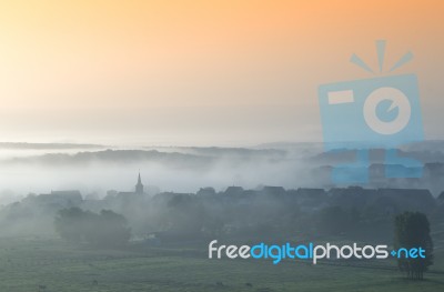 Village In The Morning Fog Stock Photo