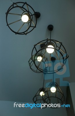 Vintage Hanging Light Bulb Over Grey Room Stock Photo
