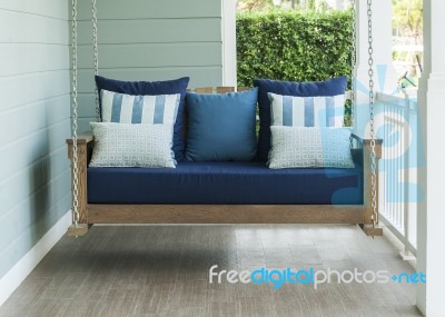 Vintage Swing And Blue Pillow Stock Photo