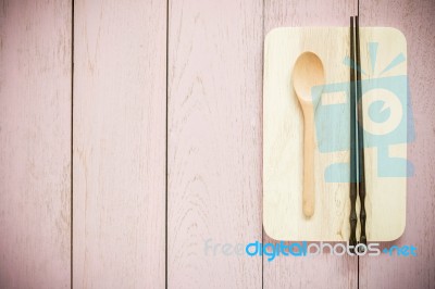 Vintage Wooden Chopsticks And Spoon On Pink Wooden Background Stock Photo