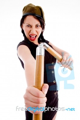 Violent Young Female Holding Nunchaku Stock Photo Violent Young Female Holding Nunchaku Stock Photo
