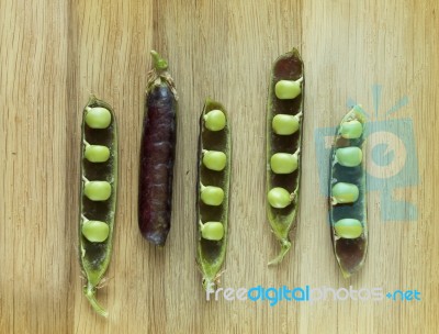 Violet Hybrid Variety Of Pea On A Wooden Desk Stock Photo