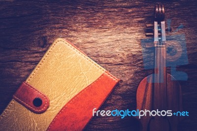 Violin And Notebook On Grunge Dark Wood Background, Vintage Style Stock Photo