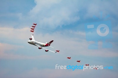 Virgin Atlantic Boeing 747-400 And Red Arrows Aerial Display At Stock Photo