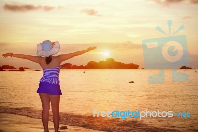 Visitors Woman Looking The Sunrise Over The Sea Stock Photo