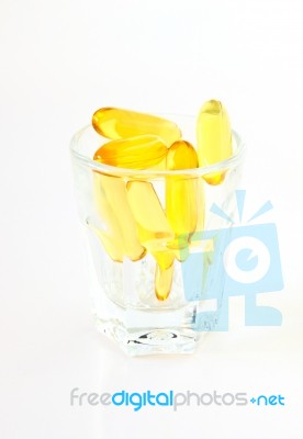 Vitamin Capsules In Glass Stock Photo