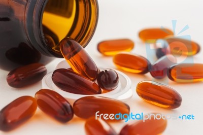 Vitamin In Capsule Spilling Out Of A Bottle Stock Photo