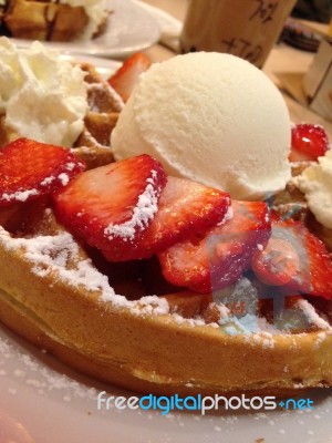 Waffle With Strawberries, Powdered Sugar And Ice Cream Stock Photo