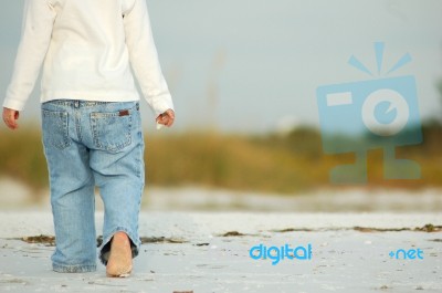 Walking Barefoot On The Beach Stock Photo
