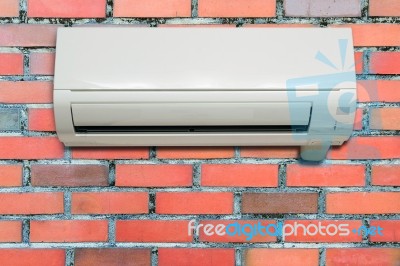Wall Air Conditioning Hanging On A Brick Wall Stock Photo