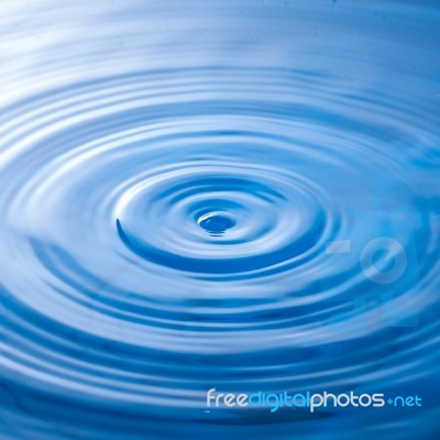 Water Drop Falling Into Water Making A Perfect Droplet Splash Stock Photo
