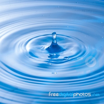 Water Drop Falling Into Water Making A Perfect Droplet Splash Stock Photo