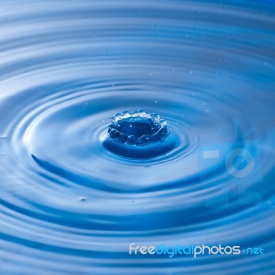 Water Drop Falling Into Water Making A Perfect Droplet Splash Stock Photo