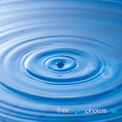 Water Drop Impact With Water Surface, Causing Rings On The Surface Stock Photo