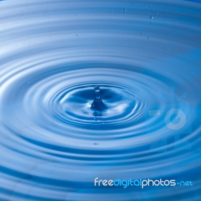 Water Drop Impact With Water Surface, Causing Rings On The Surface Stock Photo