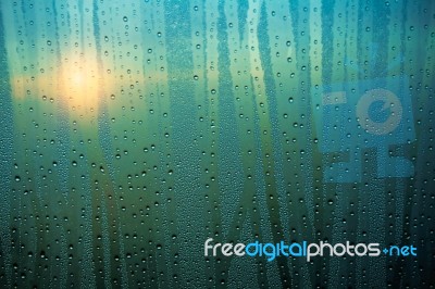 Water Droplets On Glass With The Sunrise Stock Photo