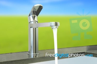 Water Flow Faucet Granite Counter On Green Environment Stock Photo