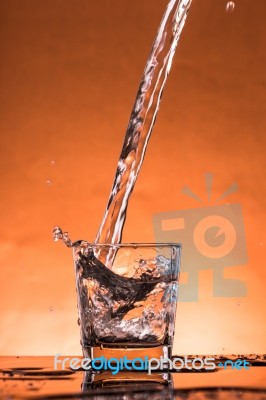 Water Is Poured Into The Glass Stock Photo