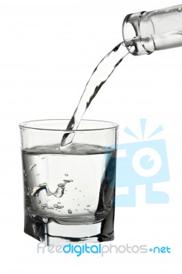 Water Pouring Into Transparent Glass Isolated On White Stock Photo