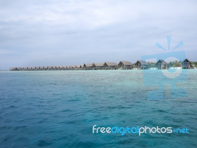 Water Villas In Vivid Clear Sea Water Stock Photo