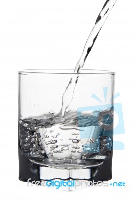 Water With Air Bubbles Pouring Into Glass, Closeup View, Isolate… Stock Photo