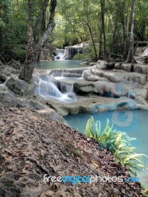Waterfall Flowing Into The Water Is Blue Stock Photo