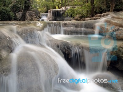 Waterfall With Water Flowing Around Stock Photo