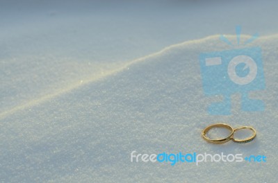 Wedding Rings In The Snow Stock Photo