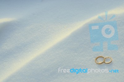 Wedding Rings In The Snow Stock Photo