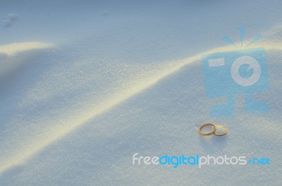 Wedding Rings In The Snow Stock Photo