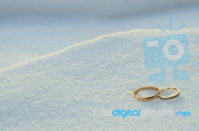 Wedding Rings In The Snow Stock Photo
