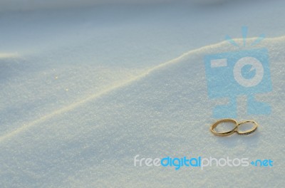 Wedding Rings In The Snow Stock Photo