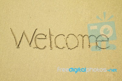 Welcome Written On Sand Stock Photo