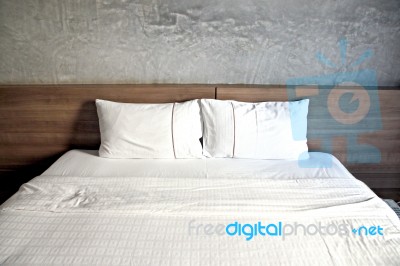 White Bed With A Pillow Or Two Stock Photo