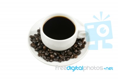 White Cup Of Coffee On Beans Stock Photo