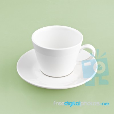 White Cup On Green Yellow Background Solid Stock Photo