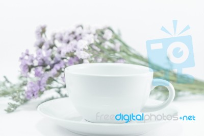White Mug Cup And Static Flower Stock Photo
