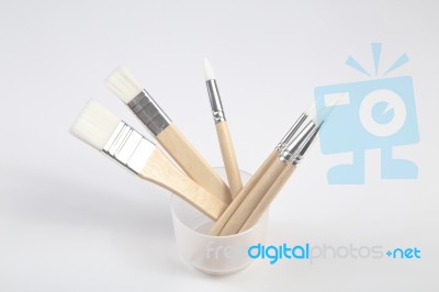 White Paintbrushes With Wooden Handle In Jar Stock Photo