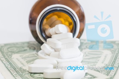 White Pills And Money On White Background Stock Photo