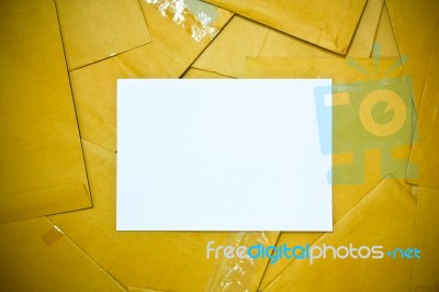 White Sheet Among Yellow Envelope Stock Photo