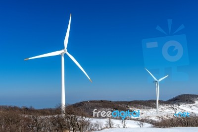 Wind Turbine And Blue Sky In Winter Landscape Stock Photo