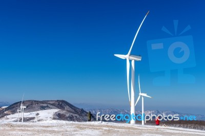 Wind Turbine And Blue Sky In Winter Landscape Stock Photo