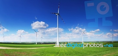 Wind Turbines In Front Of Blue Sky Stock Photo