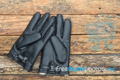 Winter Black Leather Gloves With Fur On Wooden Table Stock Photo