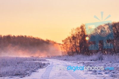 Winter Misty Colorful Sunrise. Rural Foggy And Frosty Scene Stock Photo