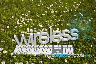 Wireless Text And Keyboard On Grass Stock Image