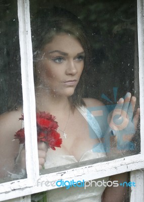 Wistful Bride At Window Stock Photo