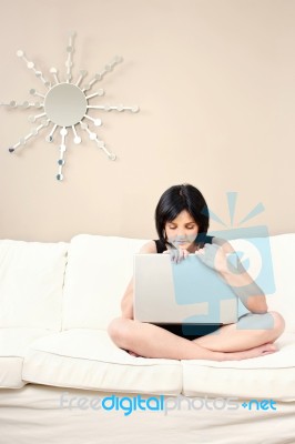 Woman And Laptop On Sofa Stock Photo