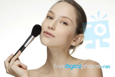 Woman Applying Make Up With Brush Stock Photo