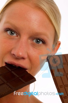 Woman Biting Chocolate Stock Photo